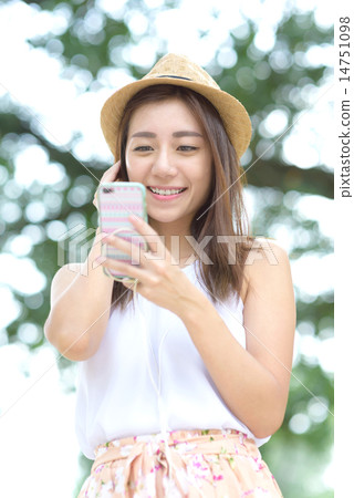 Young Chinese woman listening to music Young Chinese woman listening to music 14751098