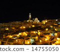 A bokeh background of a city at night with warm light spreading across it (fantastical, romantic, background material) - Night view of Matera 14755050