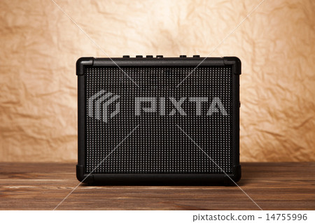Guitar amplifier on yellow background 14755996