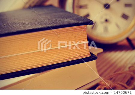 old books and an old alarm clock, with a retro effect old books and an old alarm clock, with a retro effect 14760671