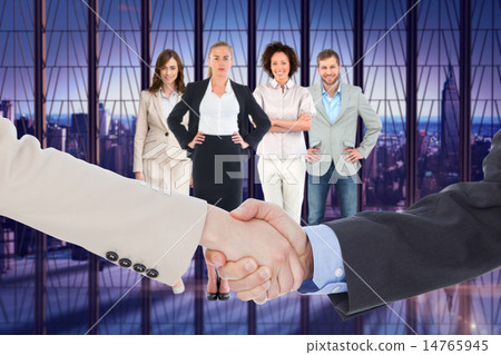 Composite image of smiling business people shaking hands while l 14765945