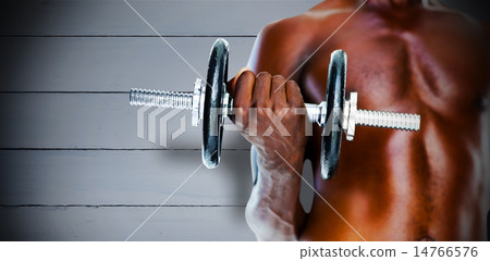 Composite image of mid section of fit shirtless man holding dumb 14766576
