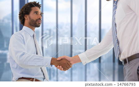 Composite image of young businessmen shaking hands in office 14766793