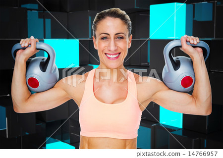 Composite image of happy female crossfitter lifting kettlebells 14766957