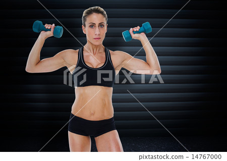 Composite image of female bodybuilder holding two dumbbells with 14767000
