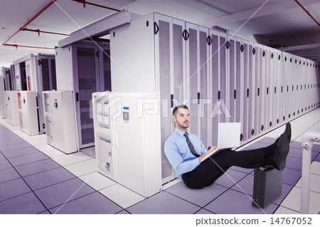 Composite image of businessman sitting on the floor with feet up Composite image of businessman sitting on the floor with feet up 14767052