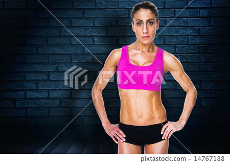 Composite image of female bodybuilder posing with hands on hips 14767188