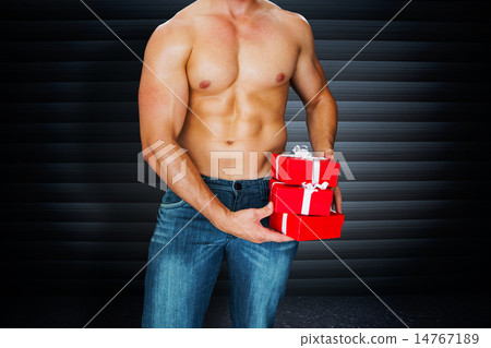 Composite image of attractive bodybuilder with gifts 14767189