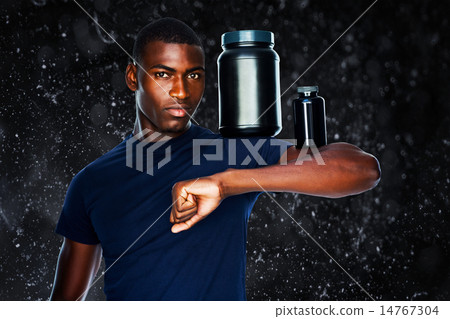 Composite image of fit man holding bottles with supplements on h Composite image of fit man holding bottles with supplements on h 14767304