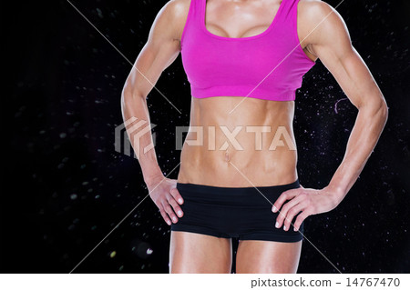 Composite image of female bodybuilder posing in pink sports bra Composite image of female bodybuilder posing in pink sports bra 14767470