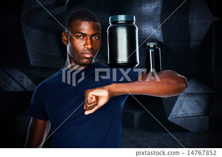 Composite image of fit man holding bottles with supplements on h 14767852