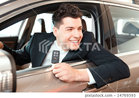 Handsome young man in dealership 14769393