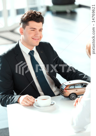 Handsome young man in dealership Handsome young man in dealership 14769621