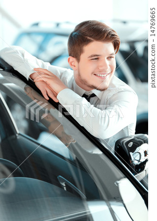 Handsome young man in dealership Handsome young man in dealership 14769665
