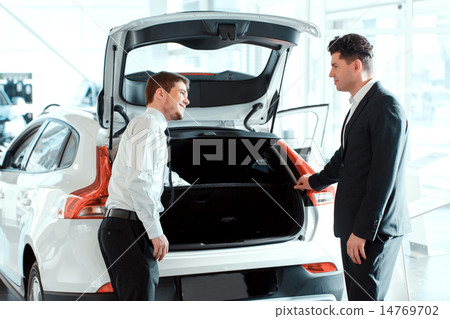 Handsome young man in dealership Handsome young man in dealership 14769702