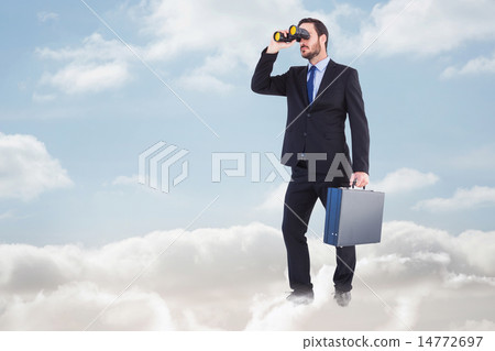 Composite image of businessman looking through binoculars holding briefcase 14772697