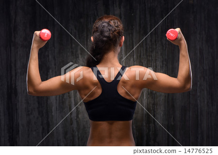 Back view of mixed race sporty woman with dumbbells 14776525