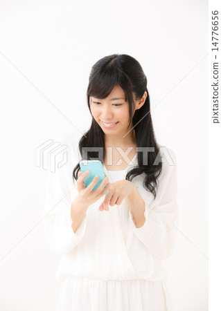 A young girl using a smartphone 14776656