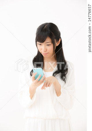 A young girl using a smartphone A young girl using a smartphone 14776657
