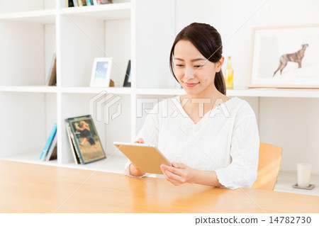 A woman using a tablet A woman using a tablet 14782730