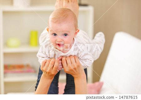 Baby playing with mother at home 14787615