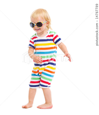 Happy baby in swimsuit and sunglasses dancing 14787789
