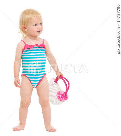 Cute baby in swimsuit with handbag looking on copy space 14787790