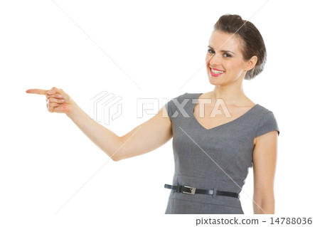 Modern business woman pointing in corner Modern business woman pointing in corner 14788036