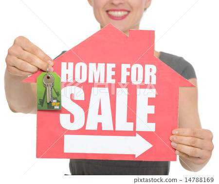 Closeup on home for sale sign and keys holding by happy female i 14788169