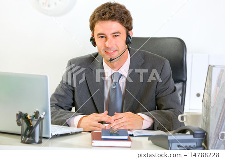 Portrait of smiling modern manager with headset 14788228