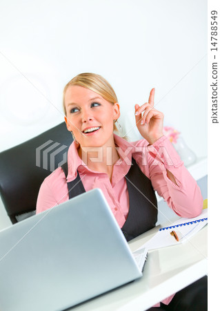 Pleased business woman got idea while sitting at office desk. Idea gesture. 14788549