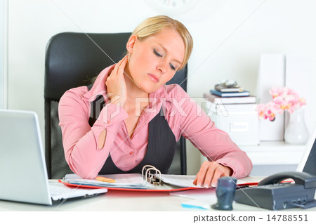 Tired business woman sitting at office desk and working with financial documents. 14788551