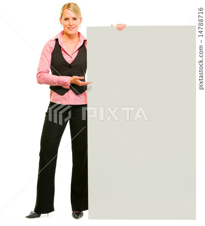 Full length portrait of smiling business woman pointing on blank 14788716
