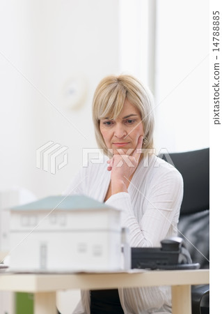 Thoughtful middle age architect woman at work 14788885