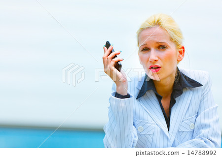 Outraged business woman with cell phone leaning on railing at of 14788992