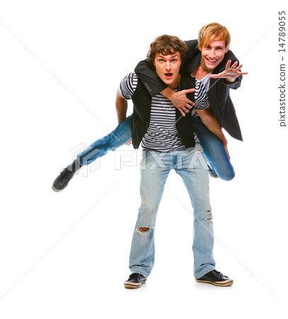 Cheerful young man piggy backing his friend. Isolated on white 14789055