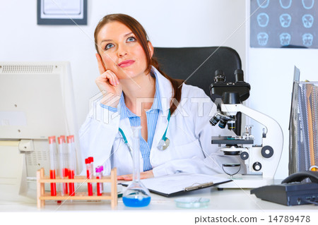 Female medical doctor sitting in cabinet and dreaming 14789478