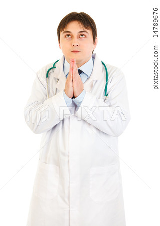 Young medical doctor praying for success. 14789676