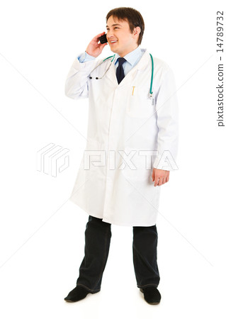 Smiling medical doctor talking on mobile phone. Smiling medical doctor talking on mobile phone. 14789732