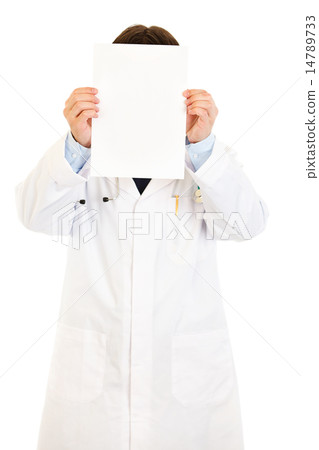 Doctor holding empty white paper in front of her face. Doctor holding empty white paper in front of her face. 14789733