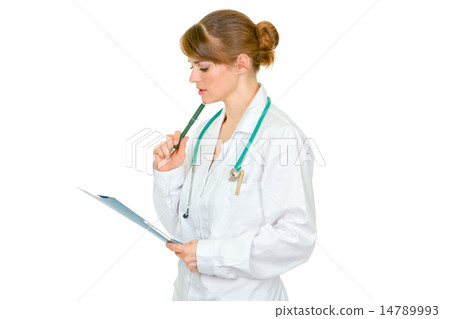 Concentrated female medical doctor looking in medical chart . 14789993