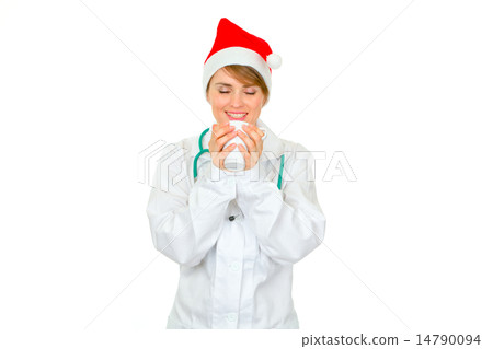 Happy medical female doctor in Santa hat enjoying cup of hot cof Happy medical female doctor in Santa hat enjoying cup of hot cof 14790094