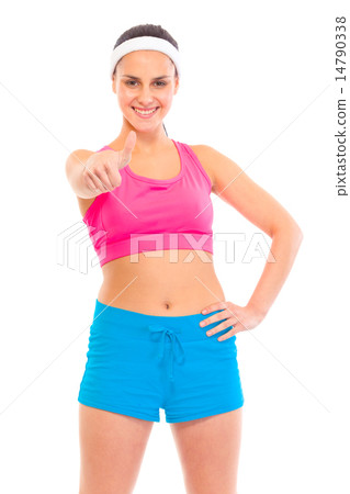 Smiling young confident girl in sportswear showing thumbs up gesture. 14790338