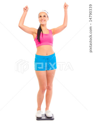 Pleased with her weight young fit girl standing on weight scale. Pleased with her weight young fit girl standing on weight scale. 14790339