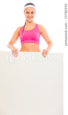 Smiling young fit girl holding blank billboard in hands. 14790350