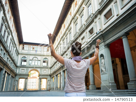 Young woman near uffizi gallery rejoicing in florence, italy. re 14790513