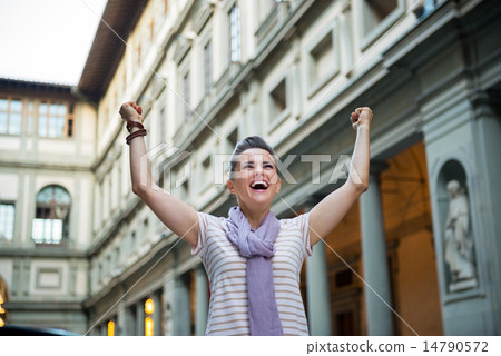 Happy young woman near uffizi gallery rejoicing in florence, ita Happy young woman near uffizi gallery rejoicing in florence, ita 14790572