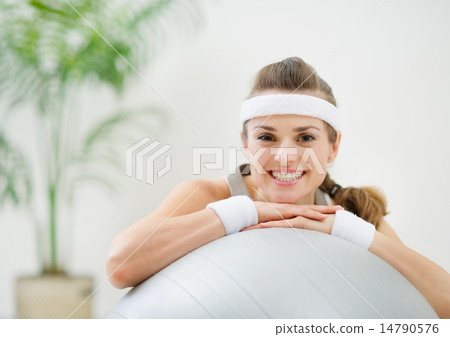 Portrait of smiling healthy woman on fitness ball Portrait of smiling healthy woman on fitness ball 14790576