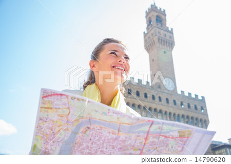 Happy young woman with map in front of palazzo vecchio in floren 14790620