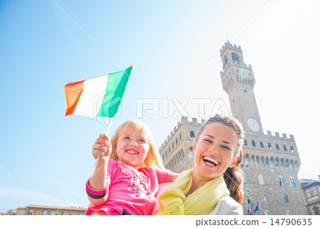 Portrait of happy mother and baby girl with flag in front of pal 14790635